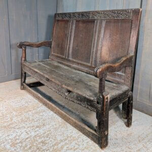 Early 17th Century Oak Panel Back Settle with Carving